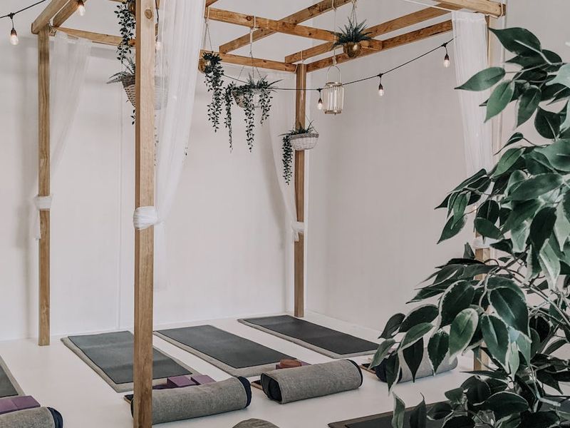 Wide shot of a minimalist yoga studio space.
